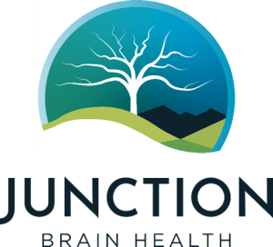 Junction Brain Health logo: a white tree within a teal oval over green hills and dark mountains.