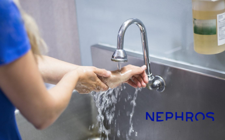A person washes hands under a running faucet in a stainless steel sink, with the brand name NEPHROS visible in blue on the lower right.