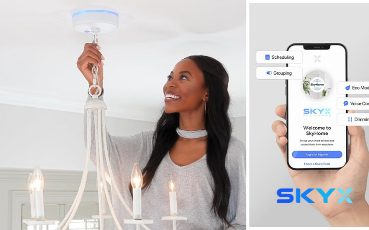 Woman installs a white, multi-bulb chandelier in a bright room, smiling as she reaches up to attach it.